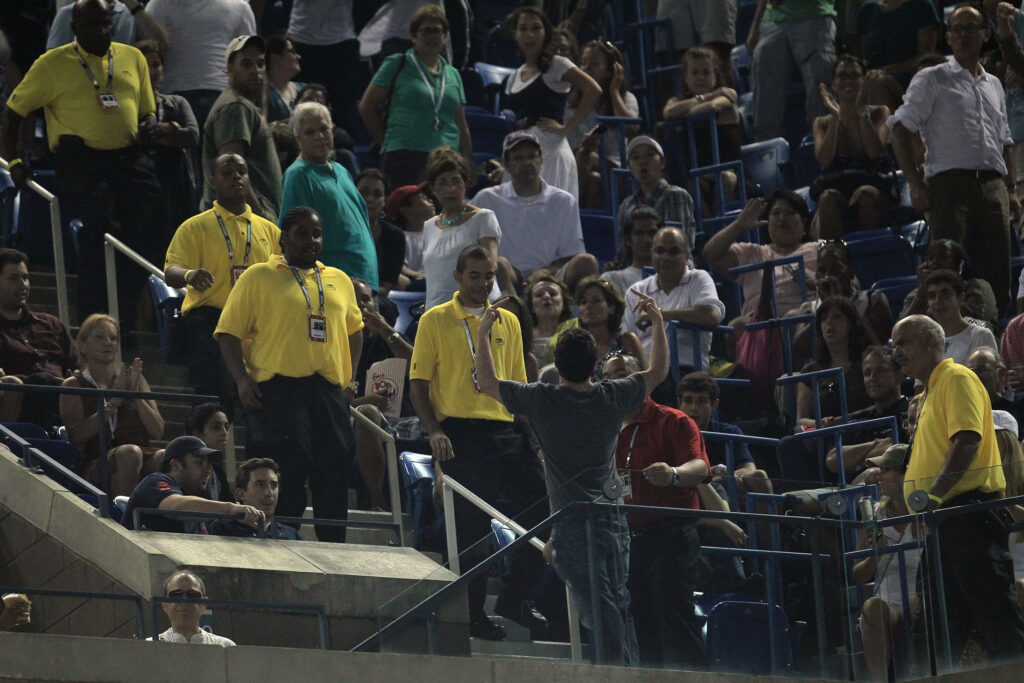 A fan being removed for a brawl during Novak Djokovic's US Open match with Philipp Petzschner in 2010