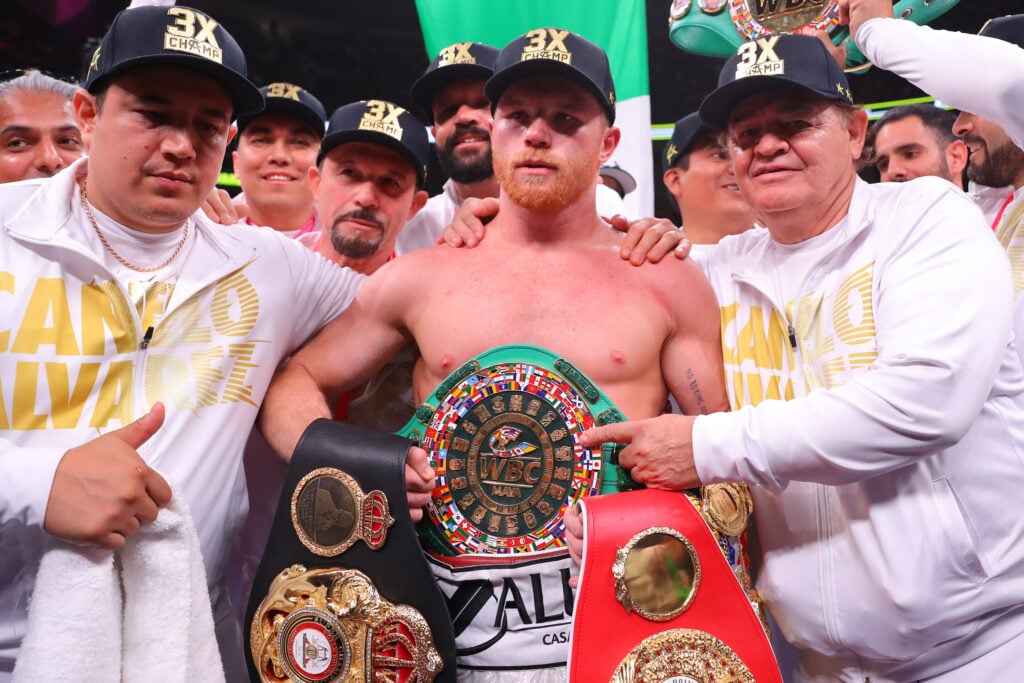 Canelo Alvarez poses with titles after beating Daniel Jacobs