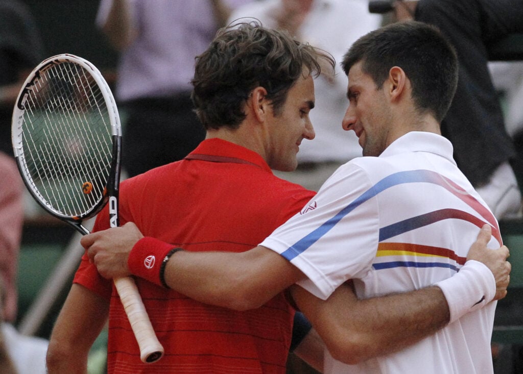 Roger Federer and Novak Djokovic embracing during the Roland Garros 2011 semi-final