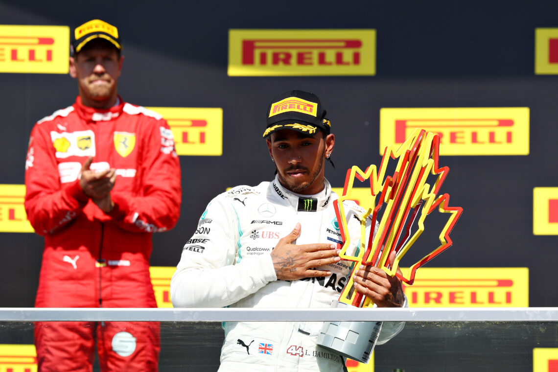 Mercedes' Lewis Hamilton celebrates winning the 2019 Canadian Grand Prix as Ferrari's Sebastian Vettel applauds.