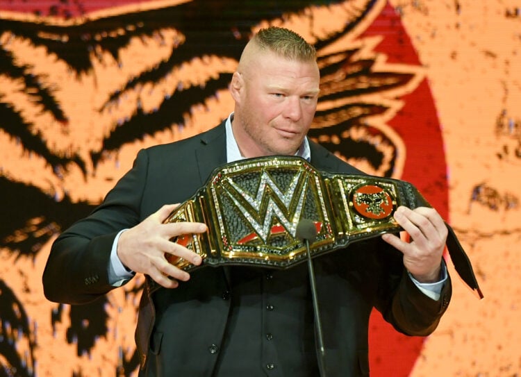 Brock Lesnar holding the WWE Championships during a Crown Jewel press conference
