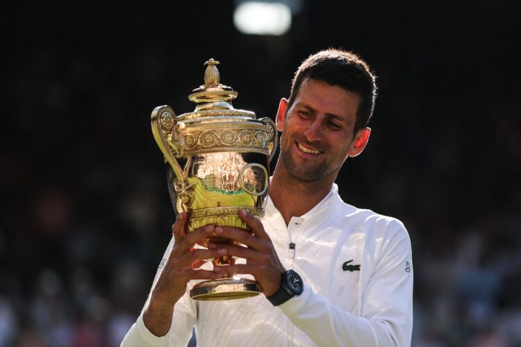 Novak Djokovic poses with his trophy after defeating Australia's Nick Kyrgios during the men's singles final at the 2022 Wimbledon Championships