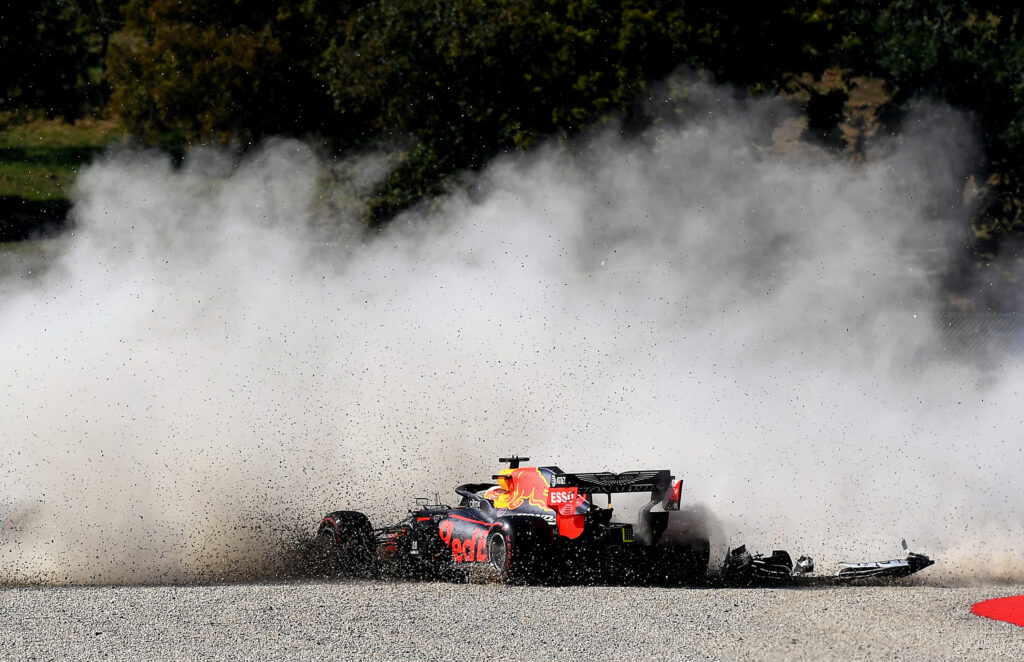 Max Verstappen's Redbull creates large dust cloud and sprays gravel after crashing at the Tuscan Grand Prix