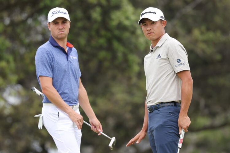 Justin Thomas of the United States and Collin Morikawa of the United States watch Morikawa's putt