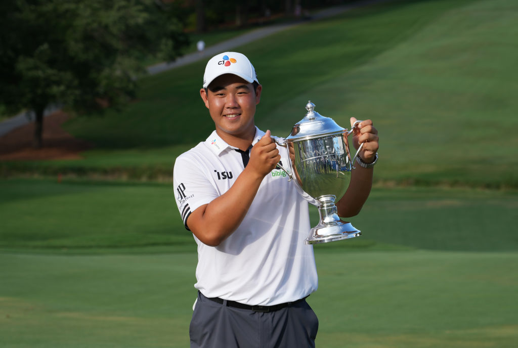 Joohyung Kim of Korea poses with the trophy at the Wyndham Championship