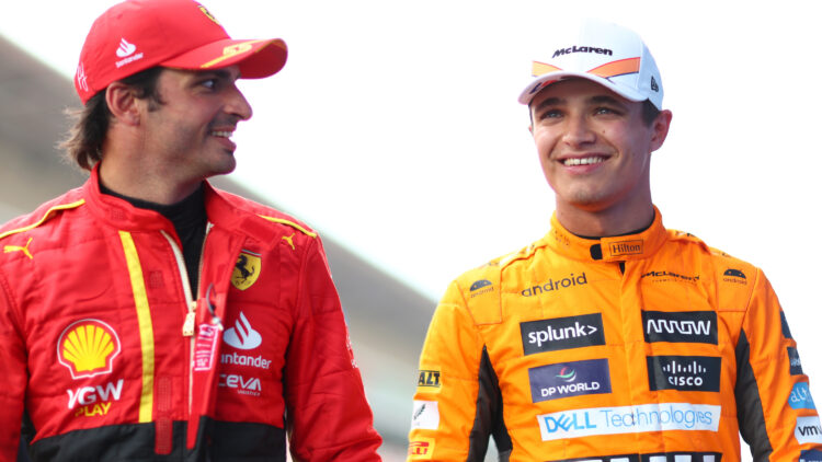 Lando Norris of McLaren and Carlos Sainz of Ferrari walk on the gird