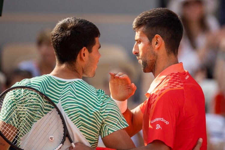 Novak Djokovic and Carlos Alcaraz talking at the net at the 2022 Roland Garros