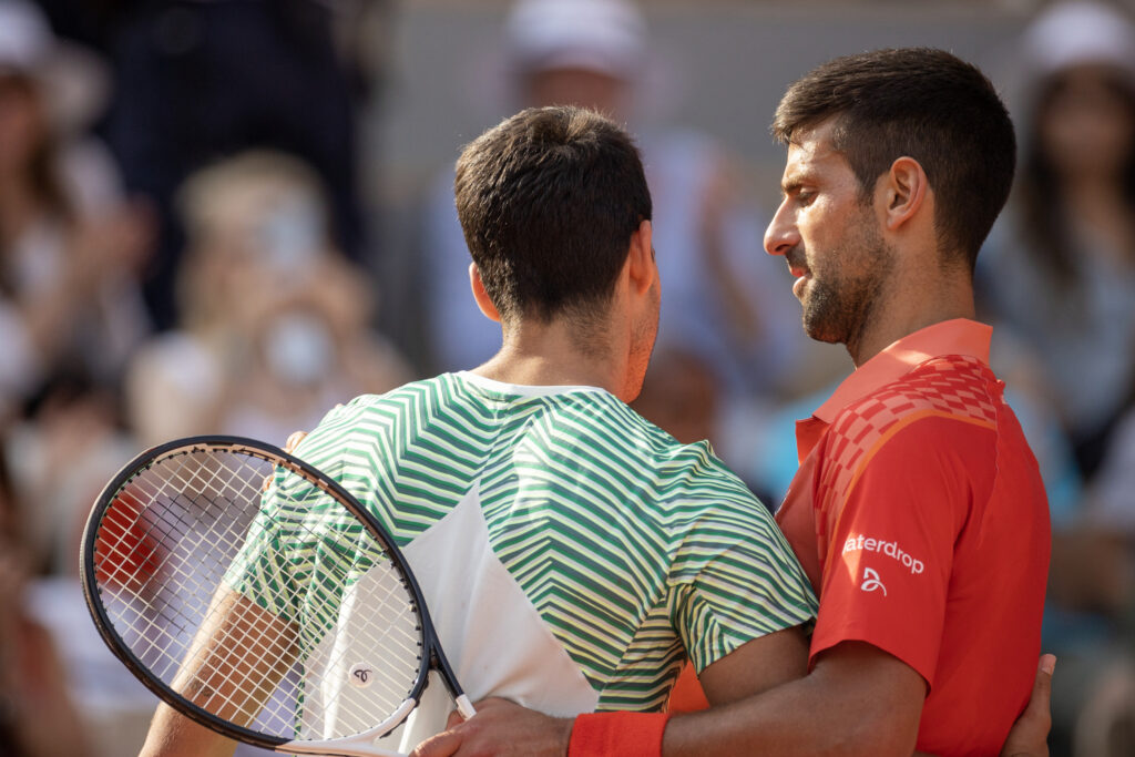 Novak Djokovic and Carlos Alcaraz talking at the net at the 2022 Roland Garros