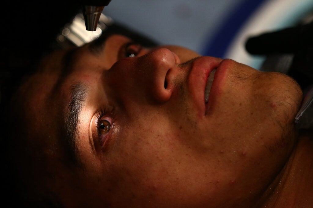 Doctor checks on Charles Oliveira after his KO loss to Cub Swanson in 2012