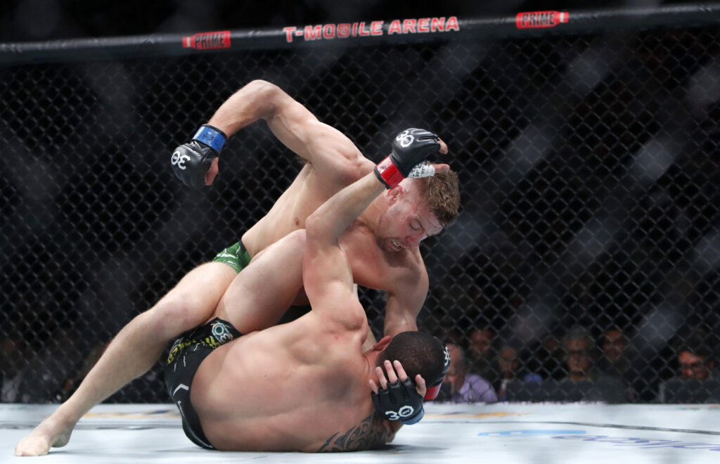 Dricus Du Plessis (top) punches Robert Whittaker in a middleweight bout