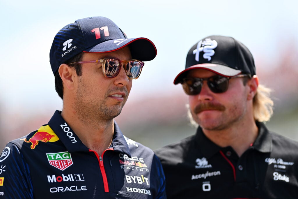 Sergio Perez of Mexico and Oracle Red Bull Racing talks with Valtteri Bottas of Finland and Alfa Romeo F1 on the drivers parade