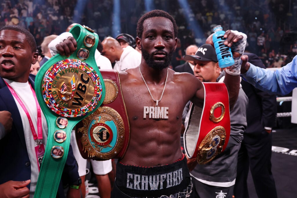 Terence Crawford celebrates with his undisputed titles after Errol Spence Jr victory