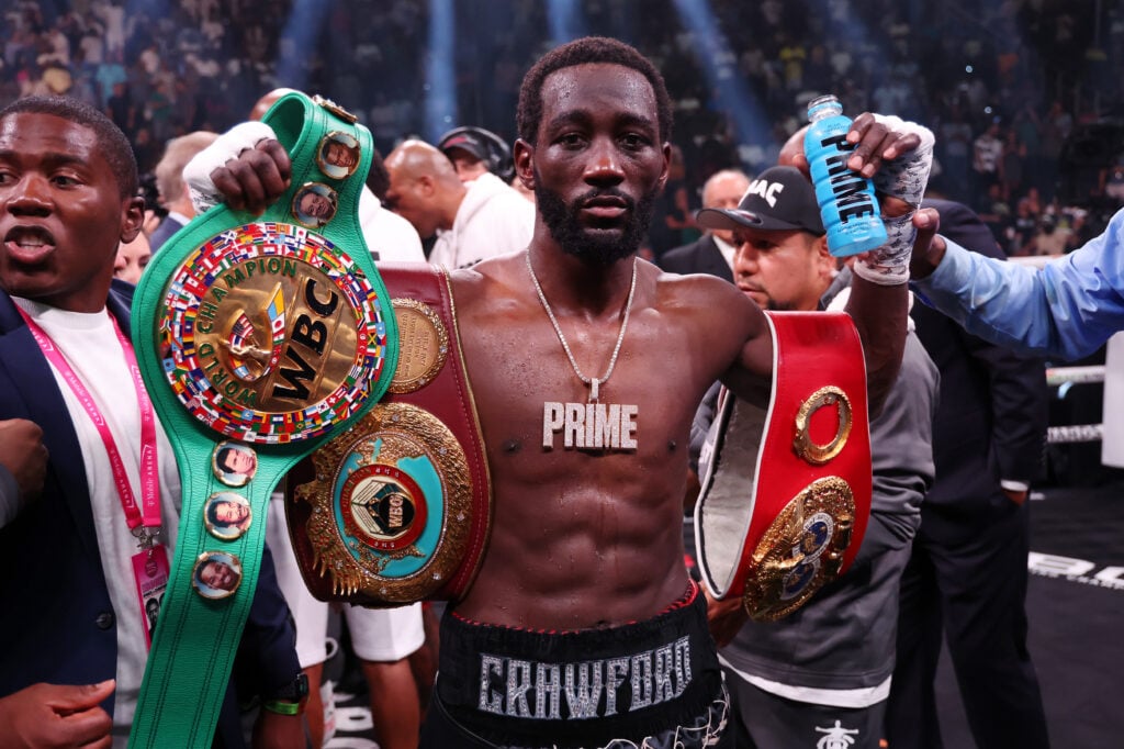 Terence Crawford celebrates with the championship belt after defeating Errol Spence Jr.