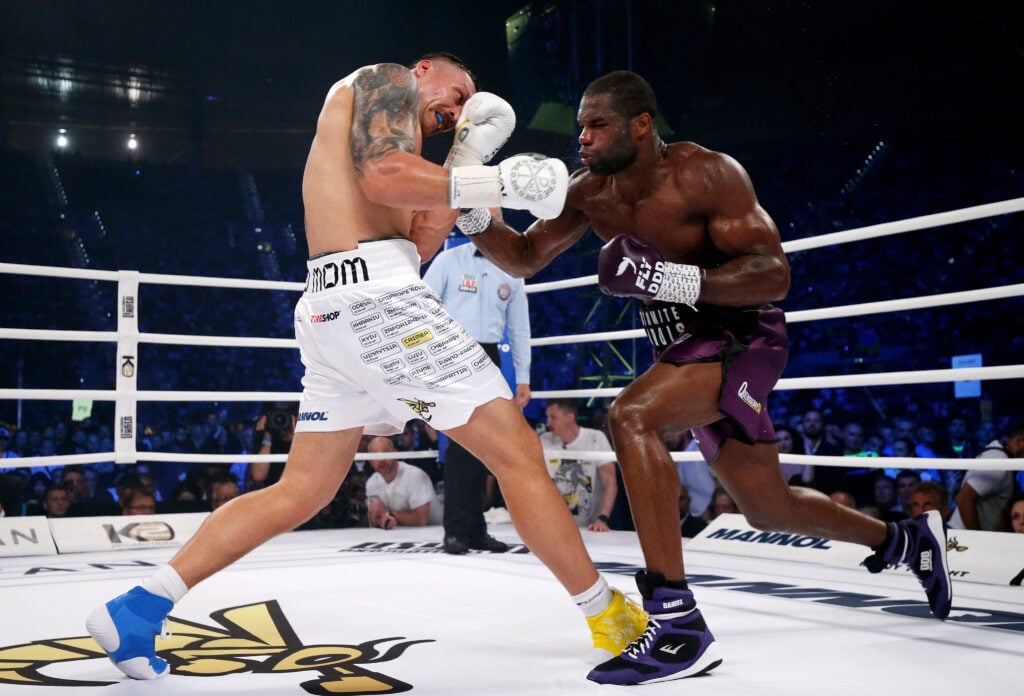 Oleksandr Usyk is punched by Daniel Dubois during their title fight in Poland