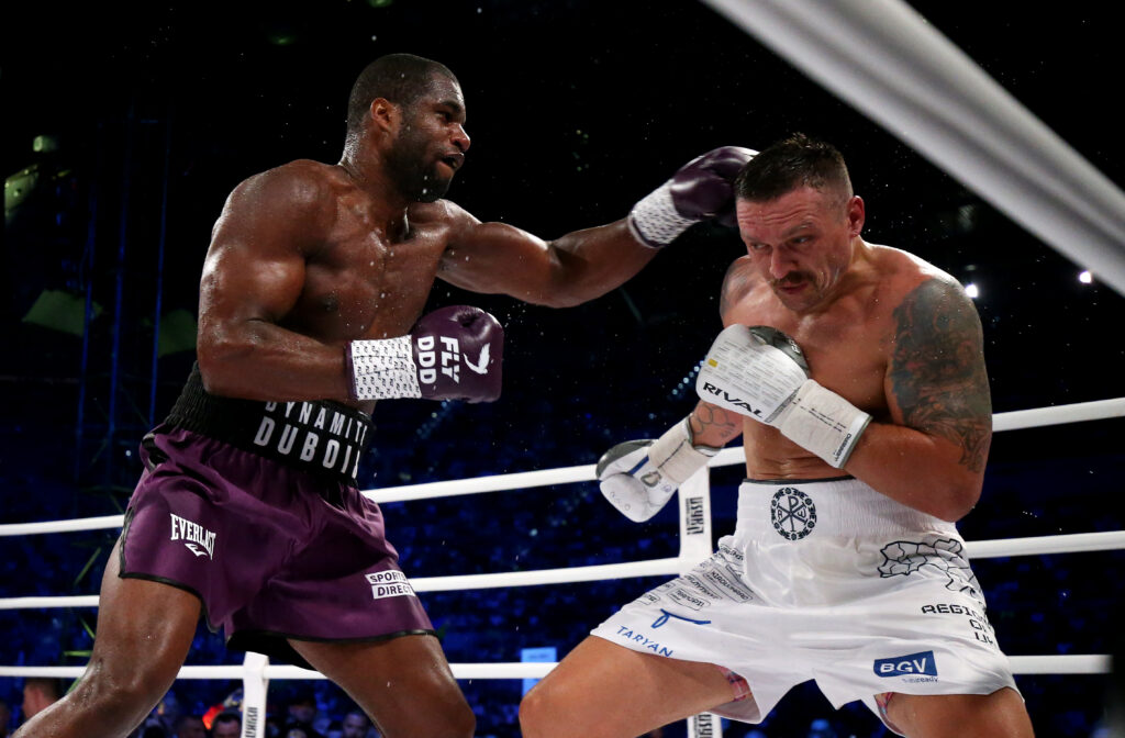 Oleksandr Usyk takes a punch to the head from Daniel Dubois during their fight in Wroclaw, Poland in 2023
