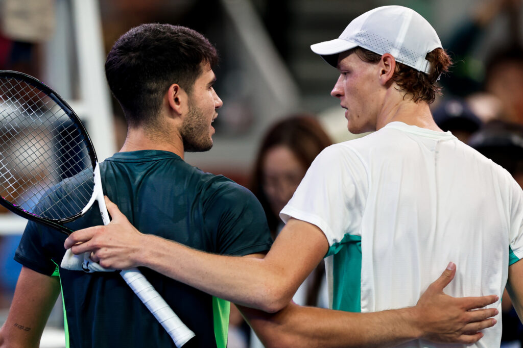Carlos Alcaraz and Jannik Sinner embracing at the net at the 2023 China Open
