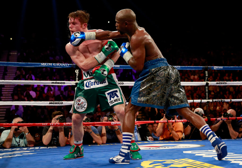 Floyd Mayweather Jr. throws a right to the head of Canelo Alvarez