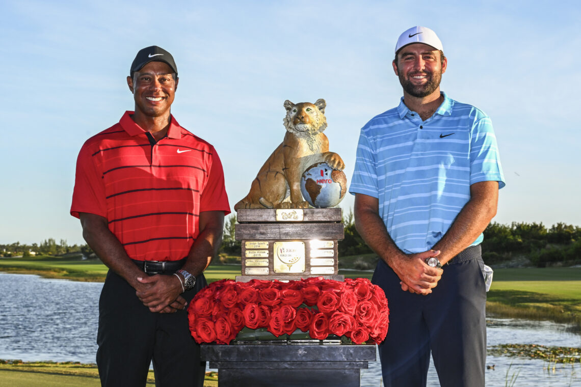 Tiger Woods and tournament winner, Scottie Scheffler, poses with the Hero World Challenge winner's trophy