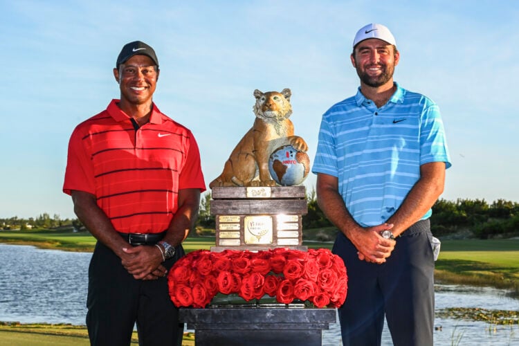 Tiger Woods and tournament winner, Scottie Scheffler, poses with the Hero World Challenge winner's trophy