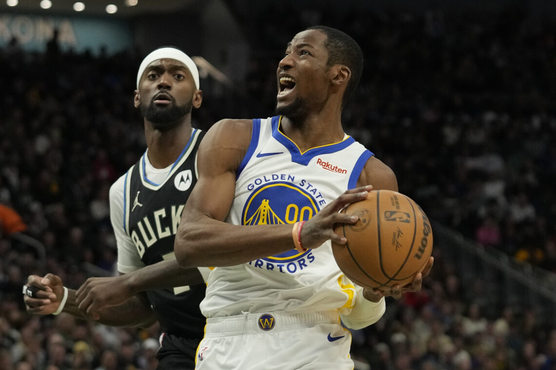 Jonathan Kuminga #00 of the Golden State Warriors goes to the basket against Bobby Portis #9 of the Milwaukee Bucks