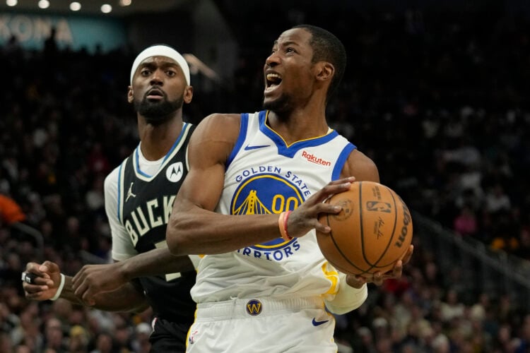 Jonathan Kuminga #00 of the Golden State Warriors goes to the basket against Bobby Portis #9 of the Milwaukee Bucks