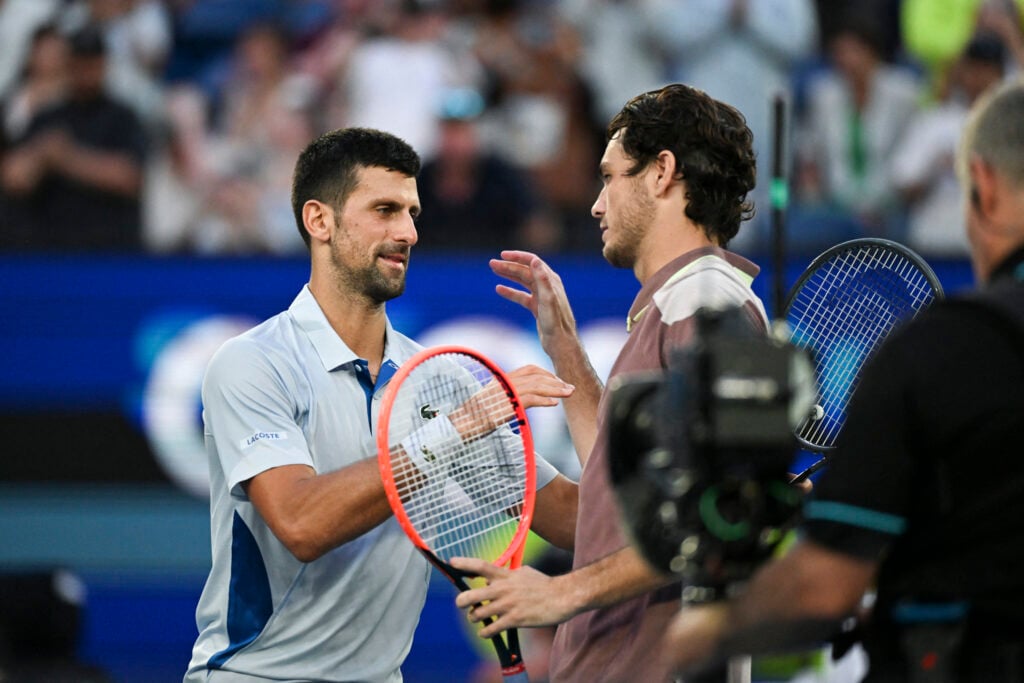 Novak Djokovic shakes hand with Taylor Fritz after their 2024 Australian Open quarter-final.
