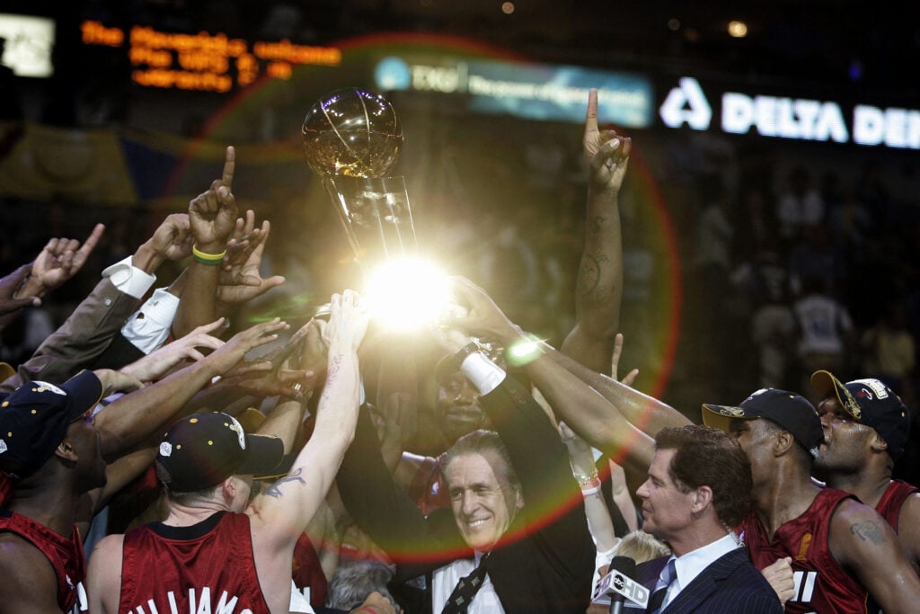 Pat Riley leads Miami Heat celebrations after the franchise secured its first NBA title in 2005.