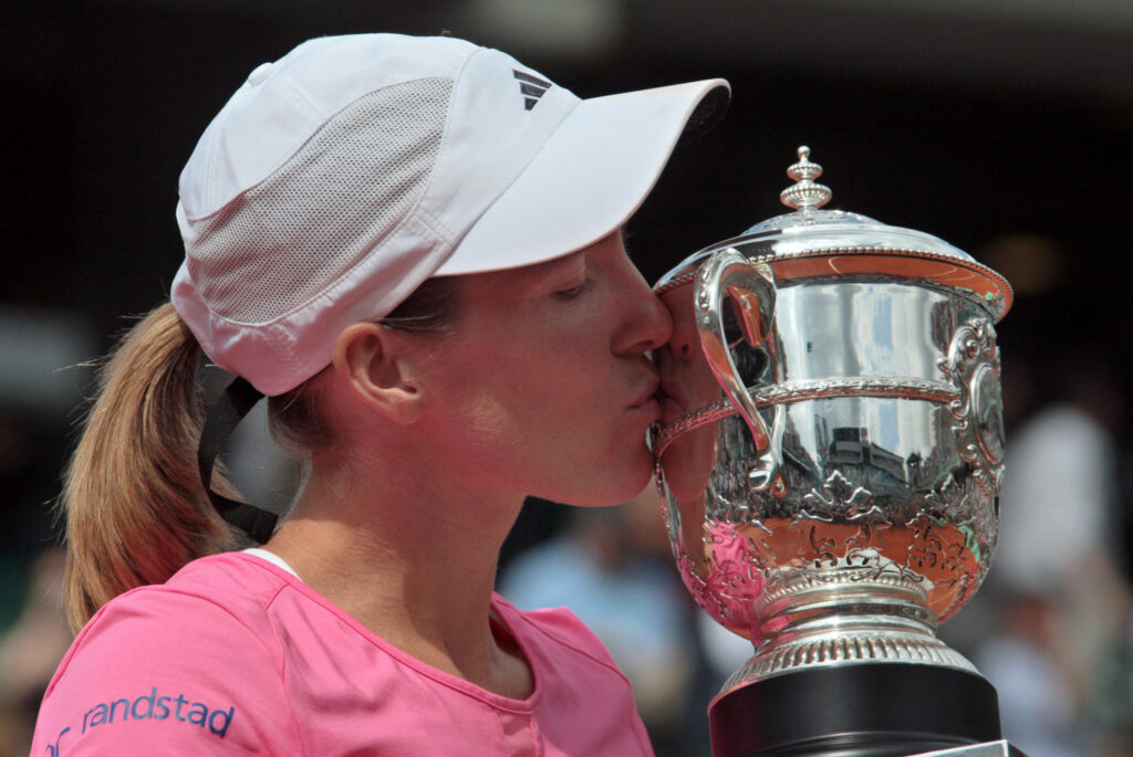 Belgian player Justine Henin poses with her trophy after winning the French Tennis Open final match against Serbian player Ana Ivanovic at Roland Garros.
