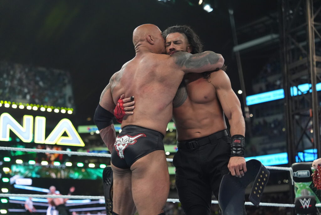 The Rock and Roman Reigns embracing at WWE WrestleMania 40