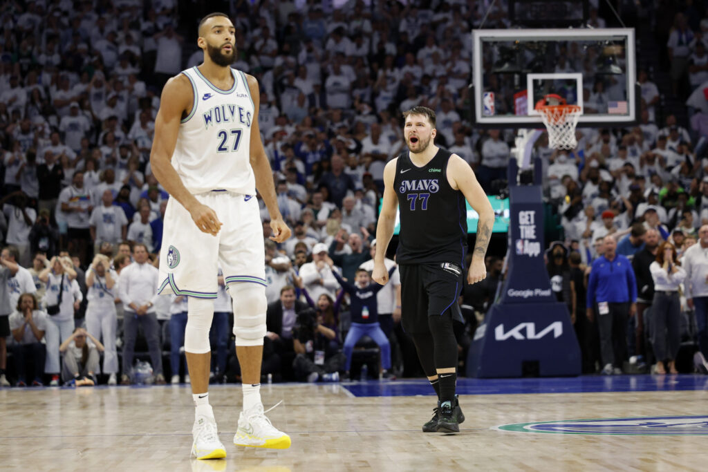 Luka Doncic #77 of the Dallas Mavericks celebrates a three point basket during the fourth quarter against Rudy Gober