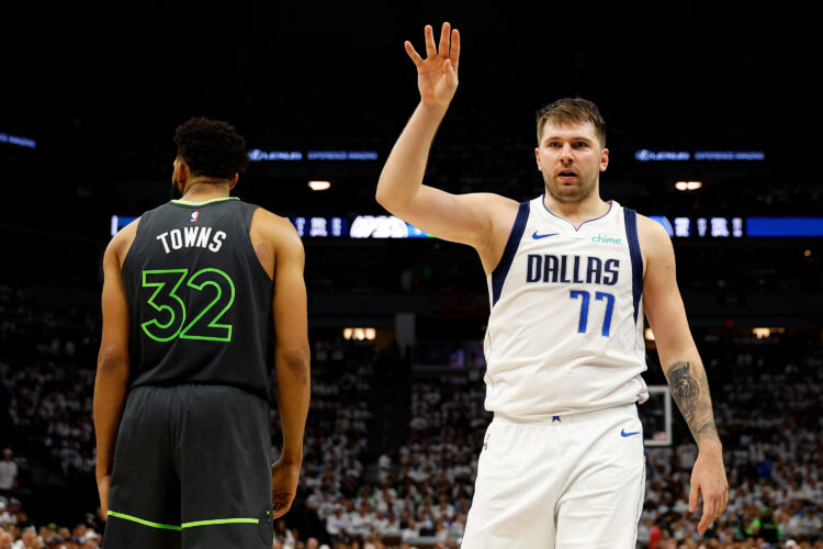 Luka Doncic #77 of the Dallas Mavericks reacts as Karl-Anthony Towns #32 of the Minnesota Timberwolves looks on