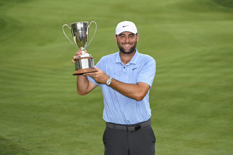 Scottie Scheffler poses with trophy after winning Travelers Championship 2024
