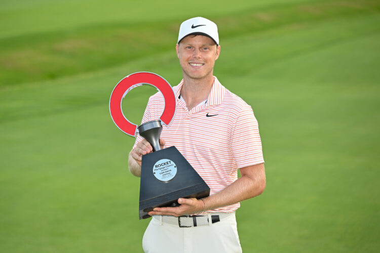 Cam Davis poses with trophy after winning Rocket Mortgage Classic 2024