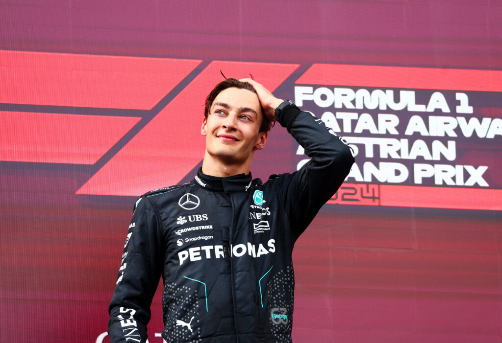 Race winner George Russell of Great Britain and Mercedes celebrates on the podium