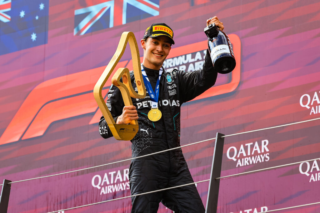 Race winner George Russell of Mercedes celebrates on the podium after the F1 Grand Prix of Austria.