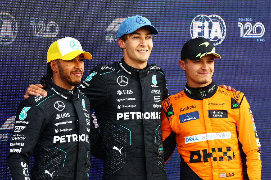 Mercdes' Lewis Hamilton and George Russell pose with Lando Norris after qualifying for the 2024 British Grand Prix.