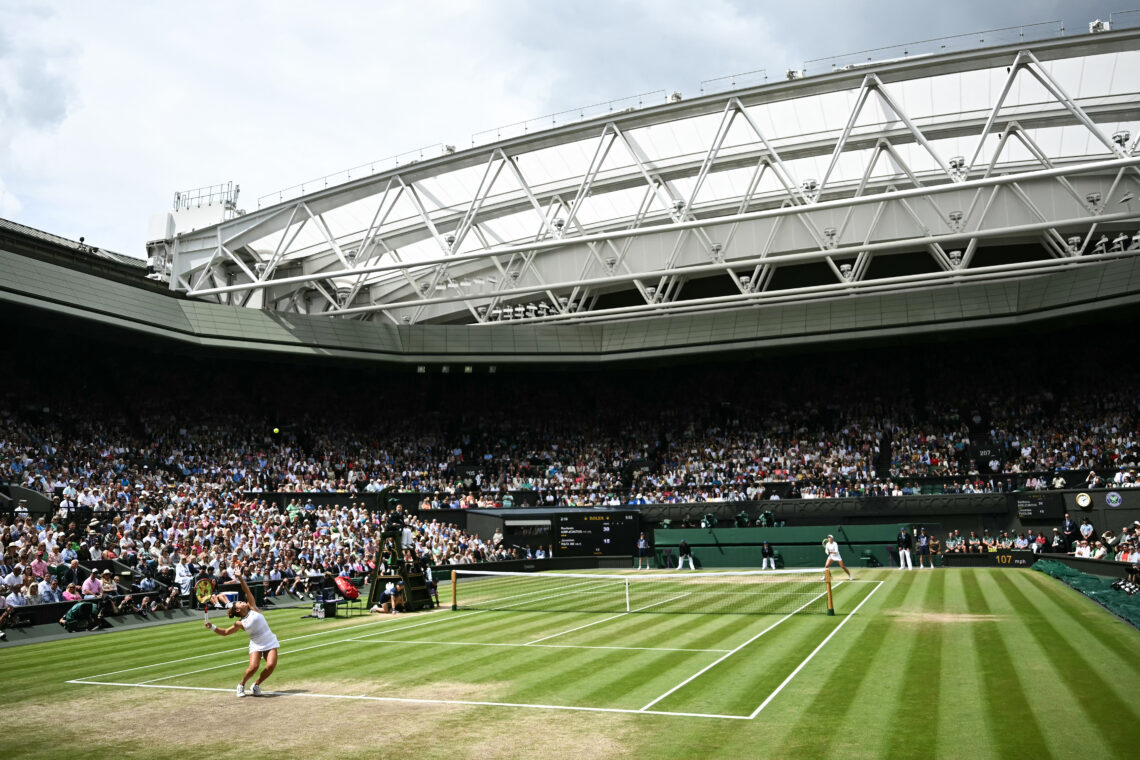 Jasmine Paolini serves under the open roof of Centre Court, against Barbora Krejcikova at 2024 Wimbledon