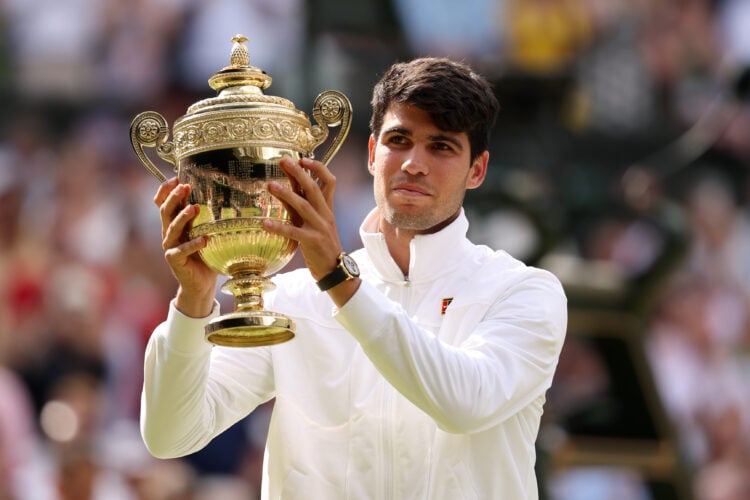 Carlos Alcaraz of Spain poses with the Gentlemen's Singles Trophy at Wimbledon 2024