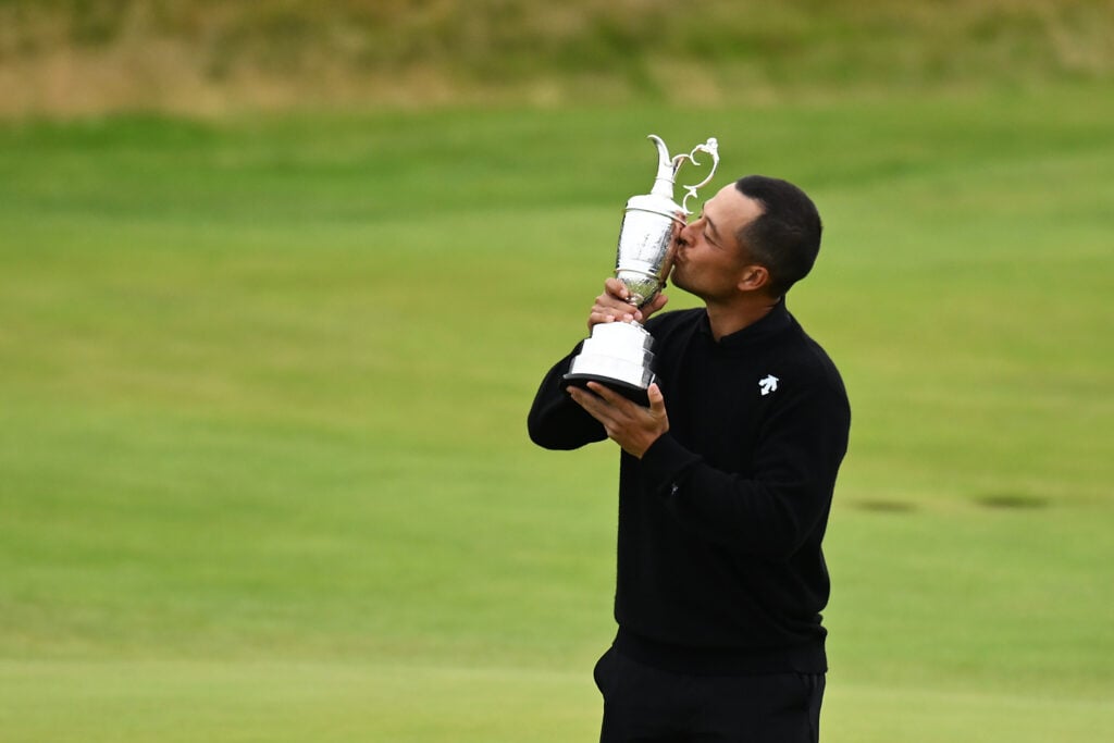 Xander Schauffele kisses the Claret Jug on the 18th green in celebration of victory on day four of The 152nd Open championship at Royal Troon