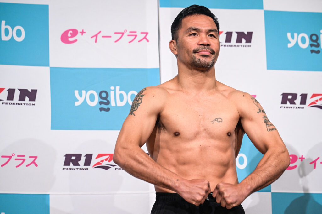 Philippine boxing legend Manny Pacquiao poses as he passes the official weigh-in