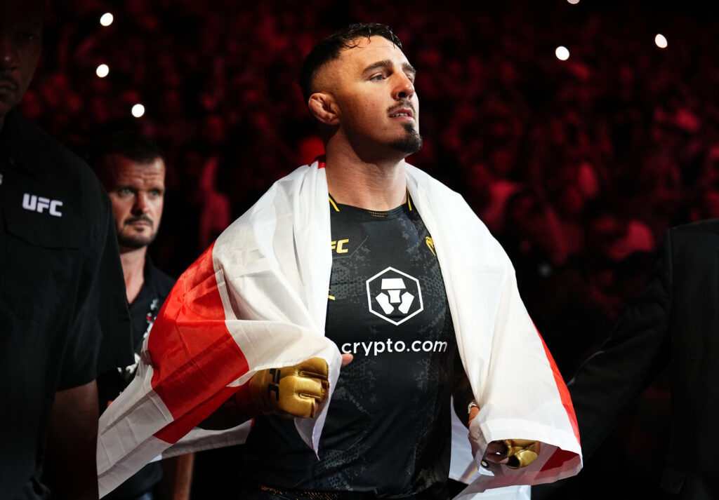 Tom Aspinall walks to the Octagon for his heavyweight title fight against Curtis Blaydes at UFC 304