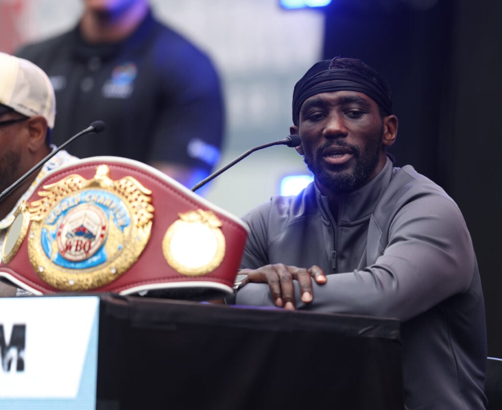 Terence Crawford poses with his welterweight title belt during a press conference