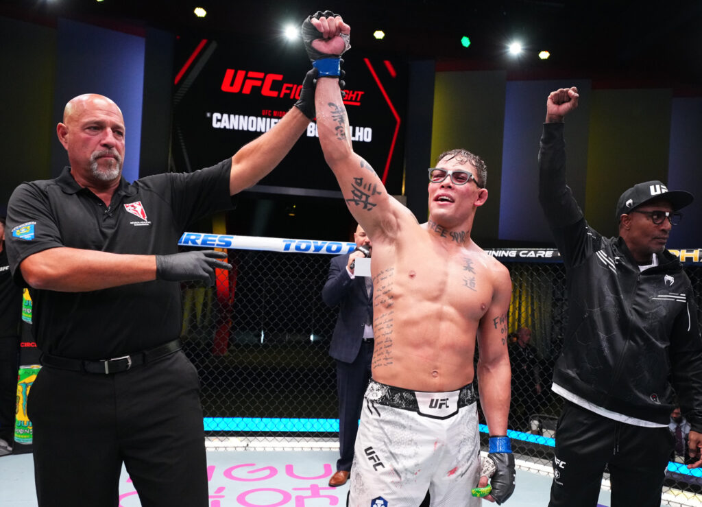 Caio Borralho has his hand raised after beating Jared Cannonier