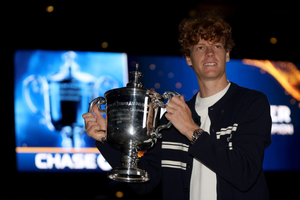 Jannik Sinner holding the 2024 US Open trophy