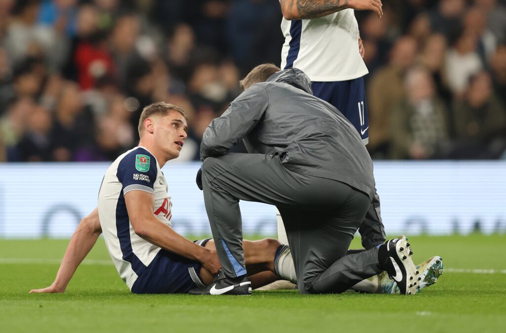Micky van de Ven getting treatment for an injury during an EFL Cup match between Tottenham Hotspur and Manchester City.