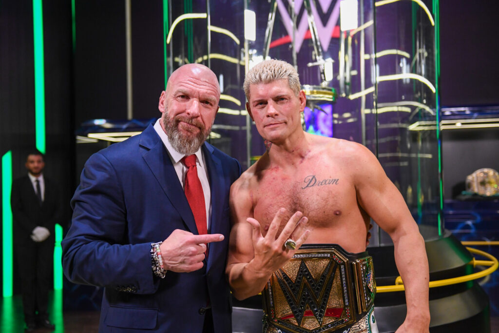 Triple H and Cody Rhodes posing with the WWE Championship and the Crown Jewel Ring at WWE Crown Jewel