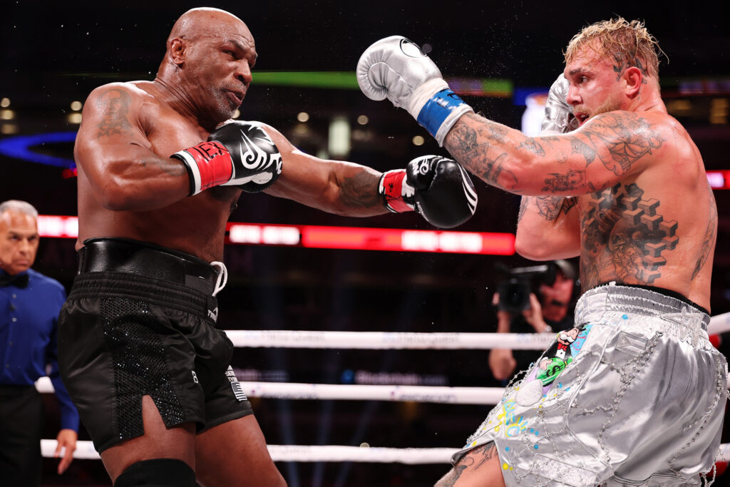 Jake Paul and Mike Tyson throw punches