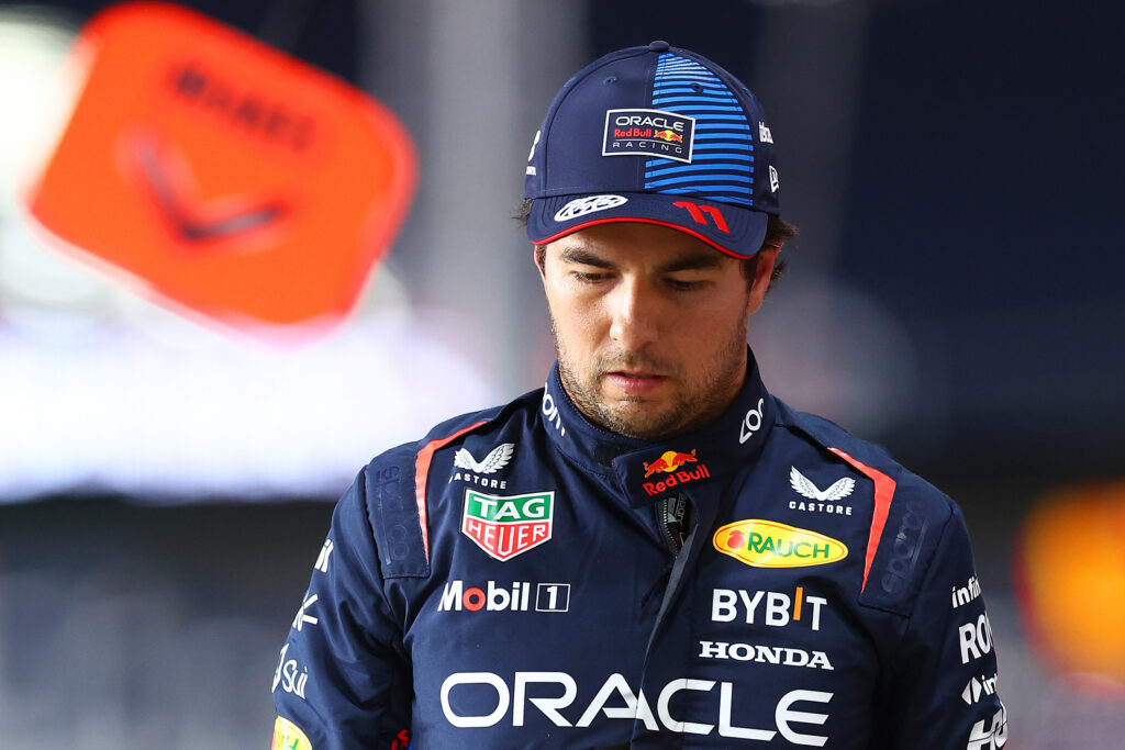 16th placed qualifier Sergio Perez of Mexico and Oracle Red Bull Racing walks in the Pitlane