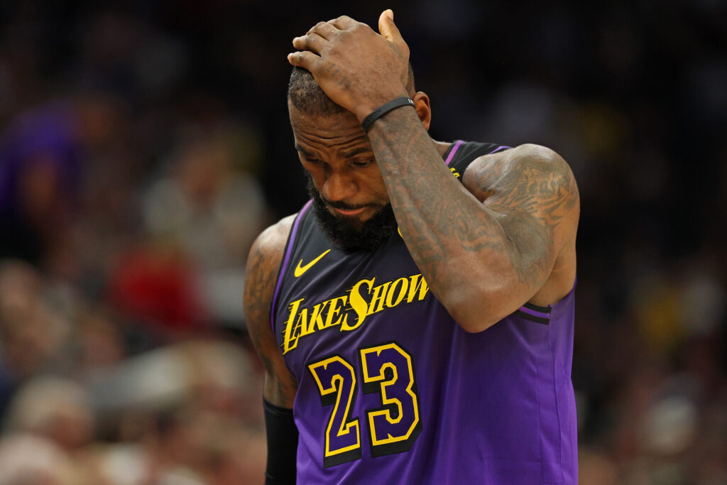 Los Angeles Lakers with a hand on his head.