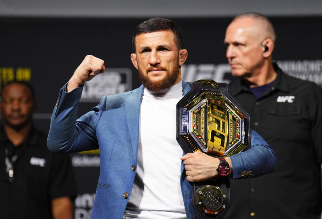 Merab Dvalishvili poses with UFC title at press conference
